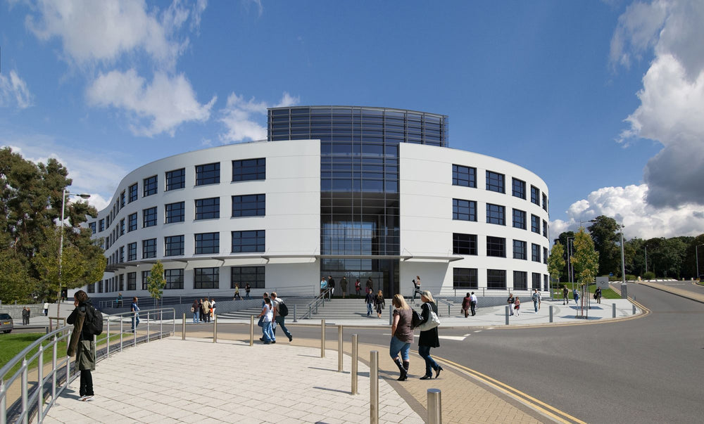 Modern office building with people walking around on a sunny day