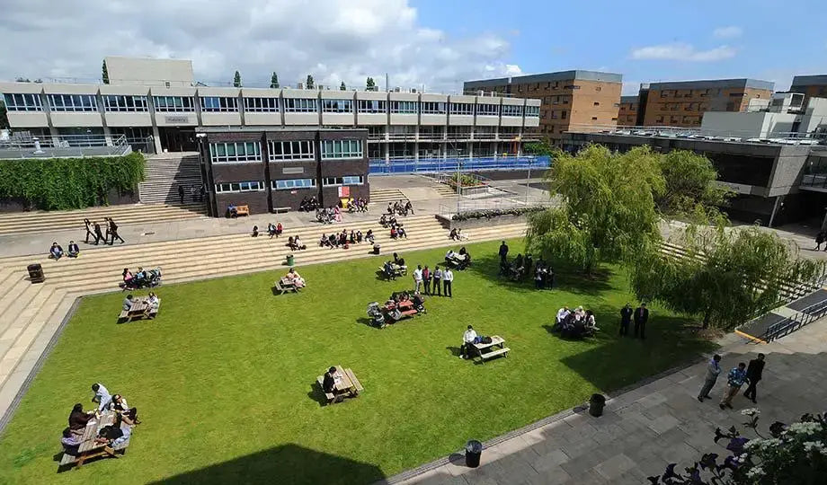 University campus with students on the grass and around buildings